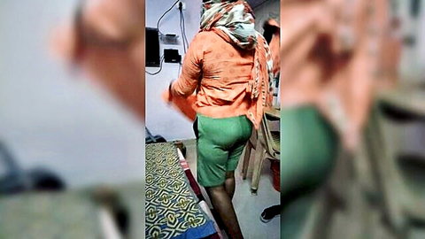 Indian woman in lodge changes dress, big ass in green shorts from behind