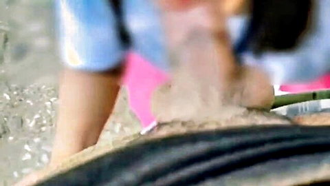 Filipina amateur squats outdoors in sand washing her shaved pussy with black hose publicly