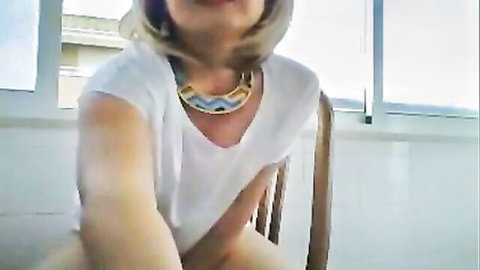 Cute short-haired mature blonde woman in white top on webcam