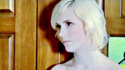 Topless young blonde in seductive profile pose by wooden door