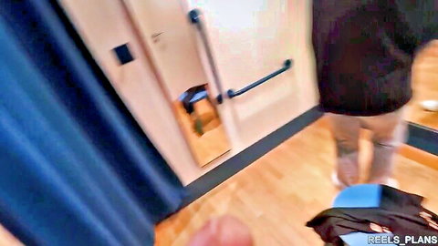Blurry view of clothed woman entering public locker room shower door teasing nudity