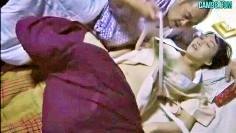 Japanese couple in intimate sex scene on colorful bed, passionate encounter