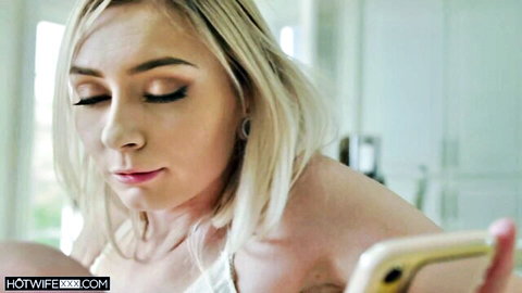 Blonde teen babe with small tits holding gold phone selfie showing cleavage