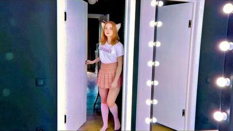 Cute redhead cosplayer in cat ears, crop top, plaid skirt and thigh-highs teasing in doorway
