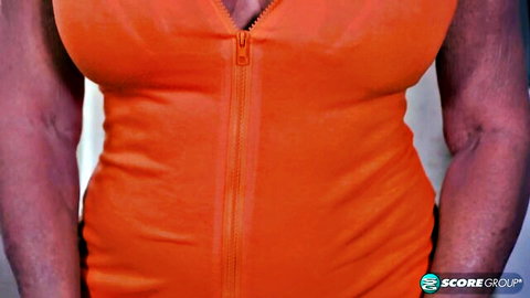 Mature blonde MILF with huge tits unzips orange top exposing deep cleavage