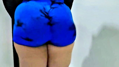 Sexy MILF's big ass in tight blue shorts getting ready
