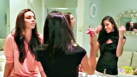 Two brunette babes in revealing tops dirty talking and posing in bathroom mirror