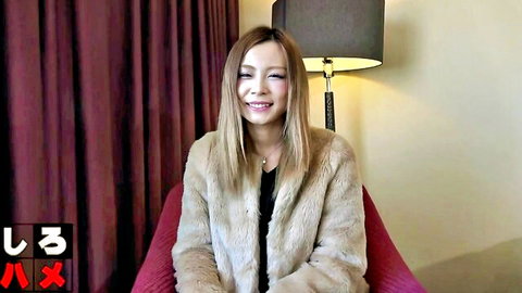 Smiling East Asian woman in fur jacket sitting seductively in red armchair