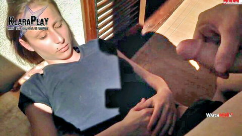 Blonde woman lying clothed on couch with eyes closed as hard cock rubs her lips
