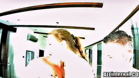Blonde woman in ponytail with man in intimate hallway embrace, creampie preview