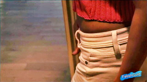 Sexy black babe teasing hips in low-rise white pants and red crop top