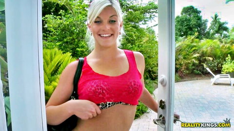 Blonde Shay Golden in sheer red top and leopard bra, smiling outdoors