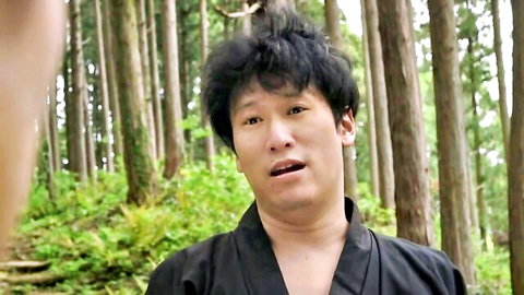 Asian man in black kimono with surprised expression in forest JAV scene
