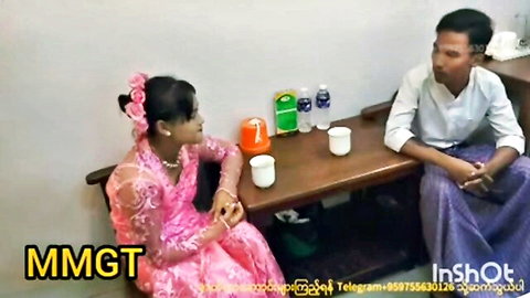 Burmese amateur couple in pink traditional dress chatting intimately