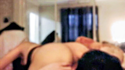 Blurry Nepali couple in intimate bedroom embrace, partial nudity