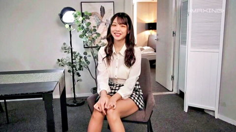 Fonda French in short plaid skirt and white blouse, smiling seductively