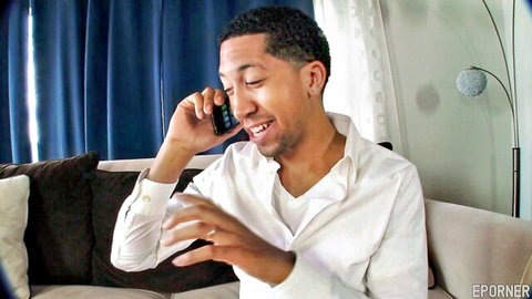 Black man smiling on phone in white shirt during blowjob scene