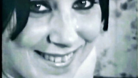 Vintage smiling brunette in classic adult film close-up