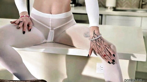 Slim fair-skinned babe in sheer white pantyhose spreads legs wide on kitchen counter exposing shaved pussy