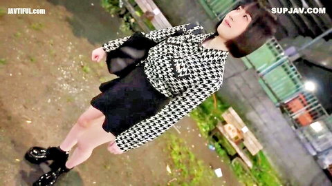 19-year-old pregnant Japanese woman in checkered jacket and short skirt outdoors
