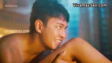 Shirtless smiling Asian hunk flexing muscles in Vivamax sex scene