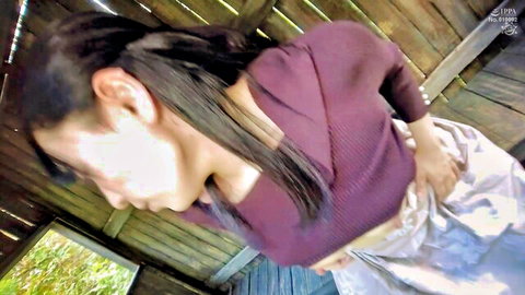 Asian woman in maroon sweater pulls down gray skirt exposing bare juicy ass cheeks in wooden hut