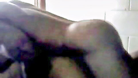 Ebony woman with big round ass lying nude on stomach in dorm