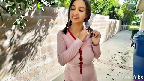 Hailey Rose smiling in pink outfit with pigtails outdoors