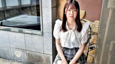 Cute Japanese schoolgirl in white blouse and pleated skirt, natural light portrait