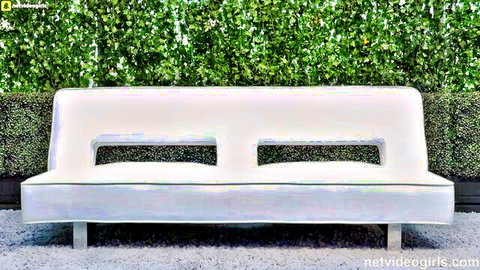 Roxxxie Blakhart as Lola on stylish white daybed in serene outdoor setting