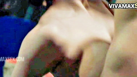 Topless Filipina with long hair and medium tits squeezing her bare breasts together in closeup