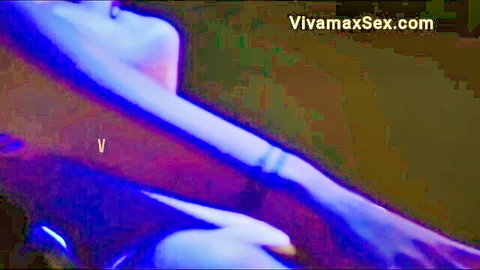Blurry purple neon-lit Asian woman arm and shoulder tease glowing skin