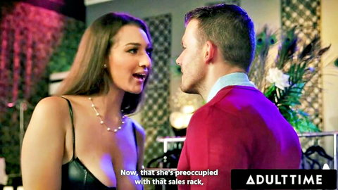Brunette beauty in deep cleavage black dress flirting closely with handsome guy in red sweater