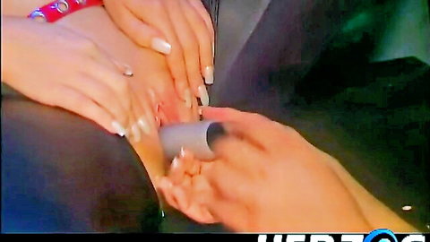 Women's hands with red and white nails gripping thick silver dildo intimately