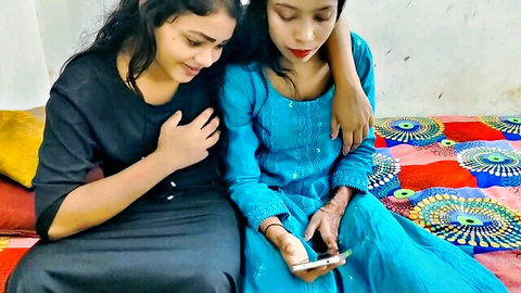 Two intimate Desi Indian women in ethnic outfits posing closely