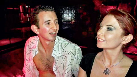 Redhead woman and man flirting intimately in Club Libertin club scene