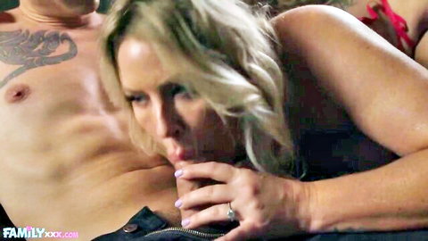 Tanned blonde MILF with huge tits licks muscular tattooed man's nipple