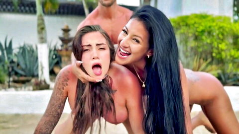 Busty nude Latina grabs ecstatic brunette's face with tongue out in outdoor threesome by pool