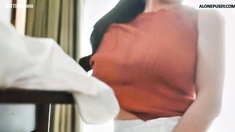 Skinny Asian babe pulls down orange top exposing her perky medium tits