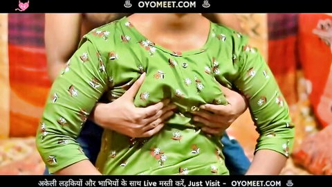 Indian woman in green floral dress groped by hands on breasts from behind