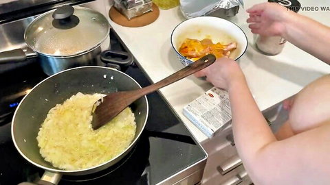 Irani woman nude cooking in kitchen, stirring food while exposed