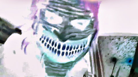 Creepy green masked devil grinning in extreme fetish adult video