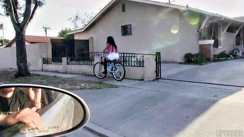 Latina brunette with big ass and tits rides bike in tight pink top on street
