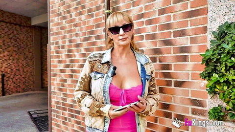 Victoria Vera, hot Spanish MILF in cleavage-revealing pink top and jacket outdoors