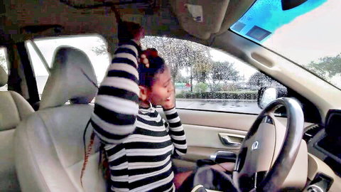 Bugatti Bubblez surprised in car, black beauty with braids