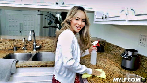 Asian MILF Linda Lan teasing in kitchen, smiling while cleaning