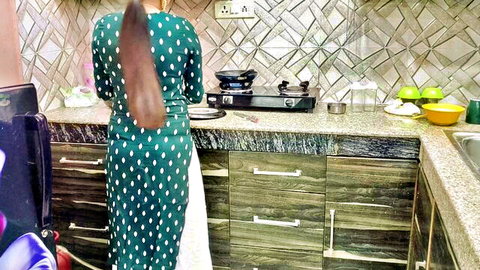 Sexy Indian Punjabi stepmom in green polka dot dress, curvy figure from behind