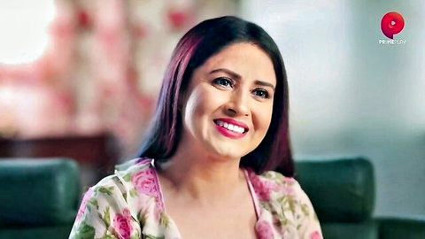 Smiling Indian MILF in floral dress from lustful adult movie