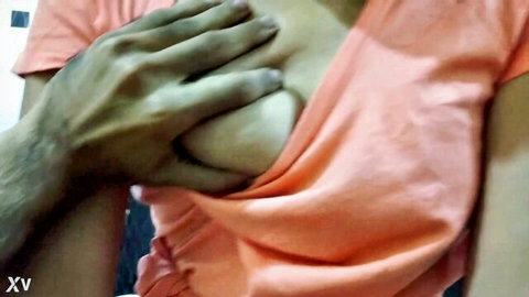 Brown hand squeezes and exposes juicy tits of South Asian girlfriend in orange top