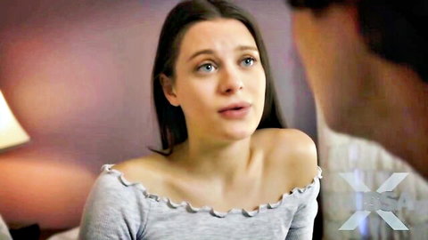 Brunette teen in off-shoulder top with medium tits looks surprised talking intimately to guy